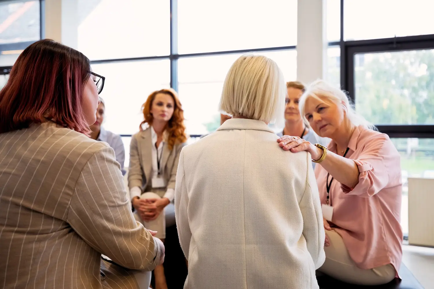 Women sharing emotional support in a circle