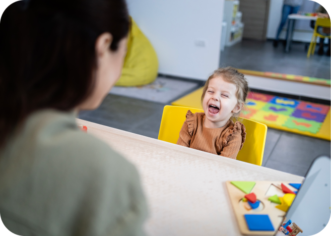 Woman kneeling, embracing smiling child
